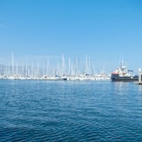 Explore the beautiful marina in Santa Barbara with numerous yachts docked under clear blue skies. Santa Barbara