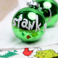 Grinch glass ornaments featuring the word