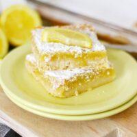 A shot of the final product, Homemade Lemon Bars, dusted with powdered sugar and cut into squares.