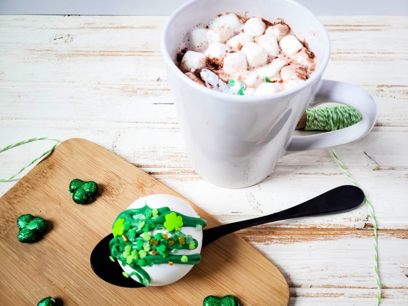 St. Patrick’s Day Hot Cocoa Bombs on a spoon