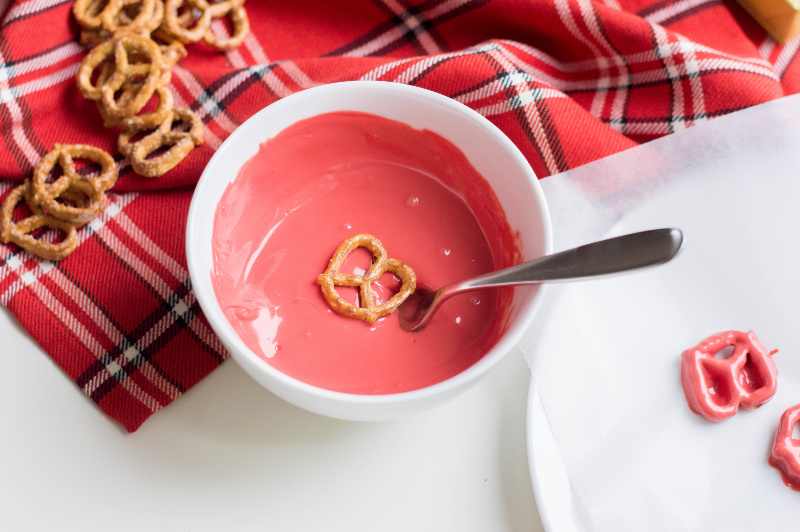 Pretzels dipped in red melted choclate