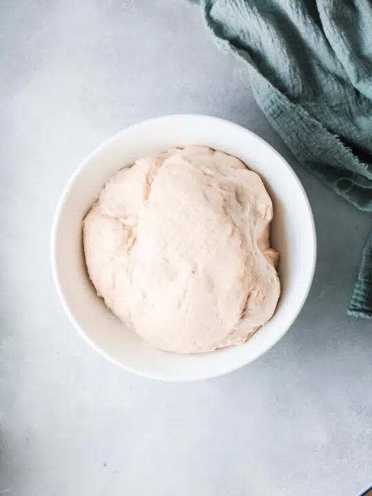 dough that has risen in a white bowl