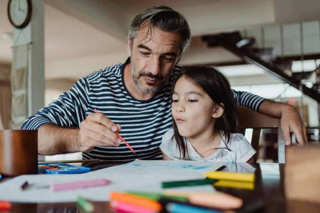 dad and daughter making art