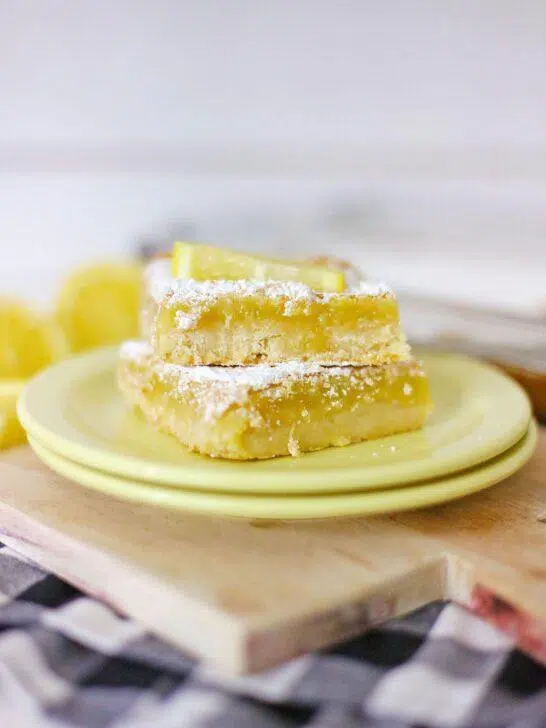 A shot of the final product, Homemade Lemon Bars, dusted with powdered sugar and cut into squares.