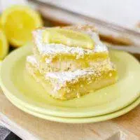 A shot of the final product, Homemade Lemon Bars, dusted with powdered sugar and cut into squares.