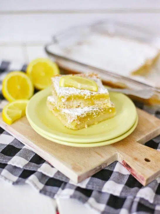 A shot of the final product, Homemade Lemon Bars, dusted with powdered sugar and cut into squares.