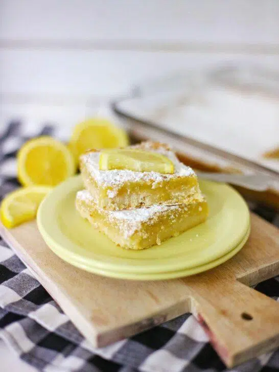 A shot of the final product, Homemade Lemon Bars, dusted with powdered sugar and cut into squares.