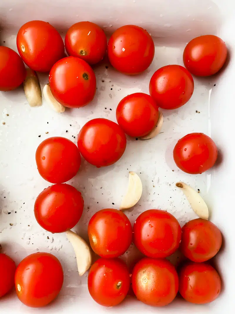 cherry tomatoes and garlic in a pan